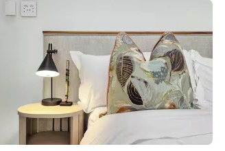 Bedroom 2 — Linen headboard with reading nook